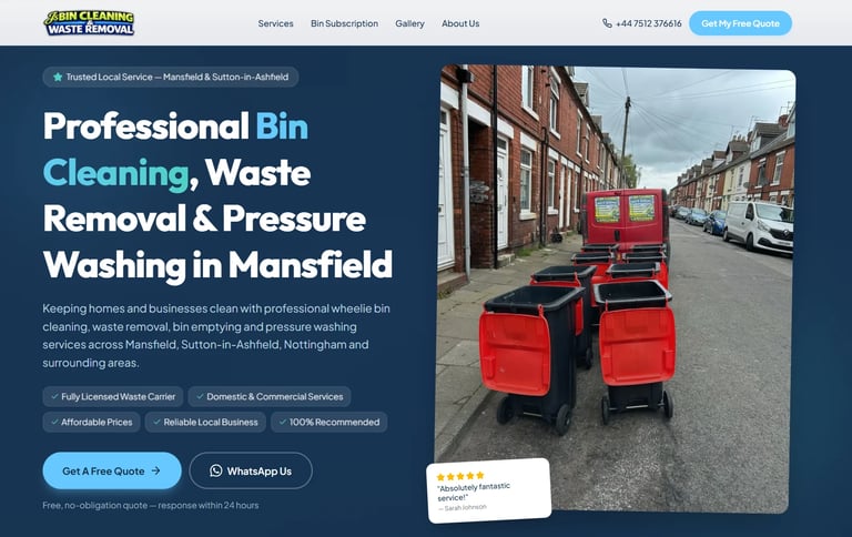 Red commercial bin cleaning machine parked on residential street with brick buildings in background